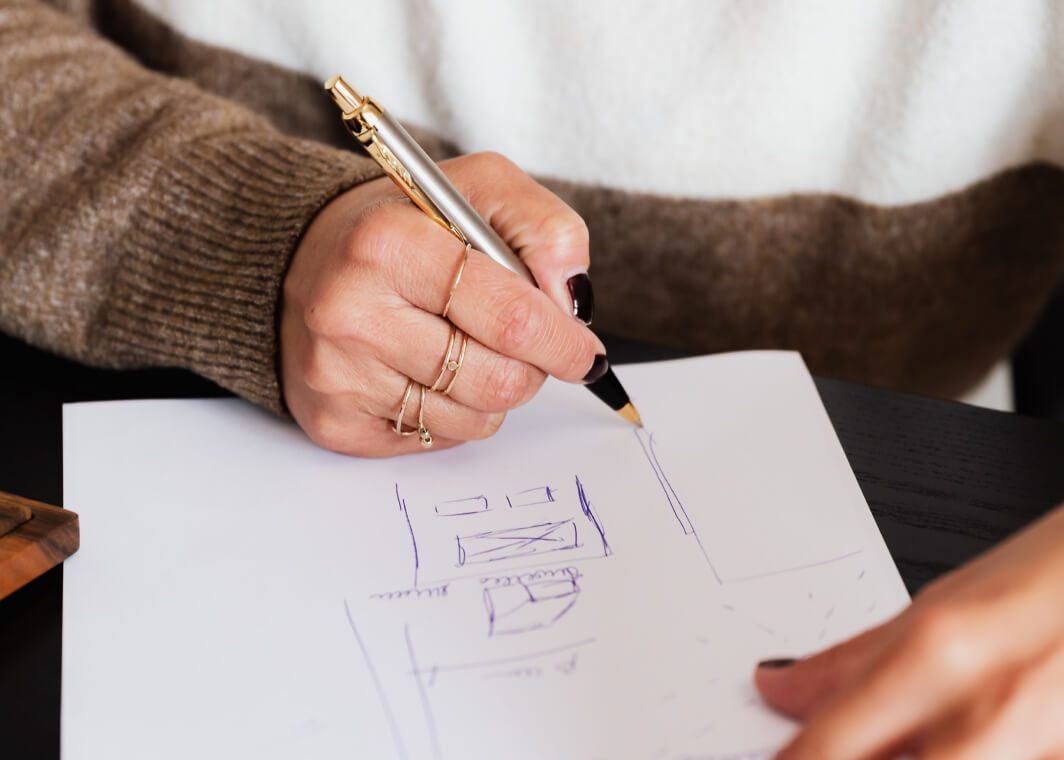 designer sketching product solutions on paper
